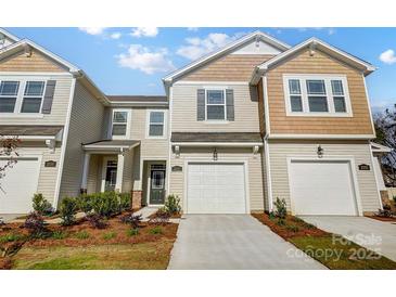 Inviting townhome featuring a one car garage, neutral siding, and well-manicured landscaping at 2340 Hedgecliff Rd # 156, Kannapolis, NC 28025