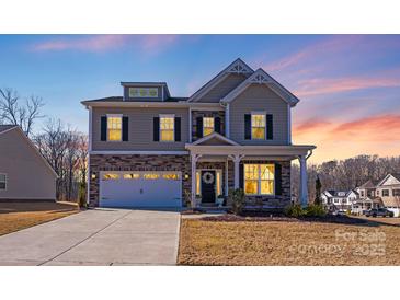 Charming two-story home with a stone and siding facade, a two-car garage, and a well-maintained front lawn at 245 Pine Eagle Dr, Rock Hill, SC 29732