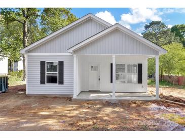 Charming single-story home with light gray siding, black shutters, and a cozy covered front porch at 265 Duke Dr, Salisbury, NC 28146