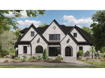 Beautiful exterior elevation featuring white painted brick, black trim, and landscaped yard at 310 Sugar Maple Ln, Weddington, NC 28104