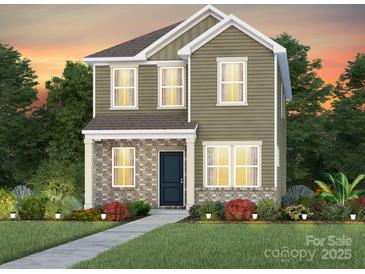 Charming two-story home featuring stone accents, manicured landscaping, and a welcoming front porch at 3616 Pamlico St # 125, Monroe, NC 28110