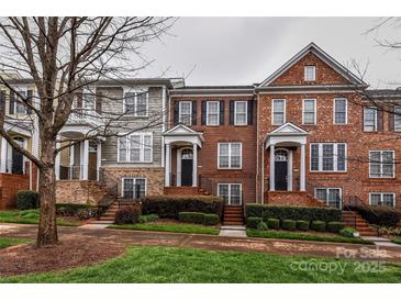 Beautiful townhomes feature brick facades, manicured landscaping, and inviting entryways at 599 Sixth Baxter Xing, Fort Mill, SC 29708