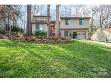 Charming two-story home featuring a well-maintained lawn and an attached two-car garage at 201 Oak Creek Dr, Charlotte, NC 28270
