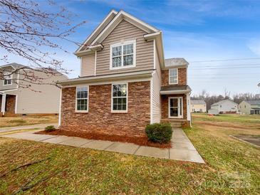 Charming two-story home boasts a stone and siding facade and a well-manicured lawn at 352 Anvil Draw Pl, Rock Hill, SC 29730
