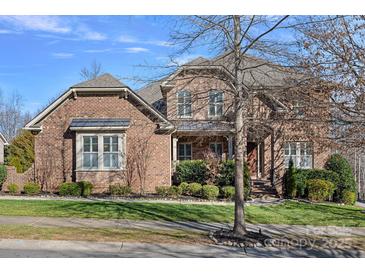 Beautiful two-story brick home with manicured lawn and professional landscaping in a suburban neighborhood at 3608 Mcpherson St, Waxhaw, NC 28173