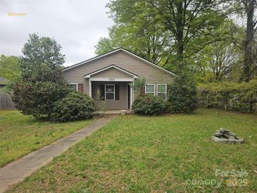 Charming single-story home with a well-maintained front yard and inviting walkway leading to the entrance at 5315 Airport Dr, Charlotte, NC 28208