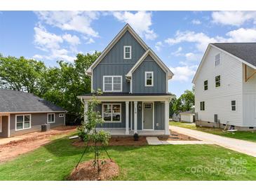 Inviting two-story home with a manicured lawn, covered porch, and well-maintained landscaping at 110 Walters St, Huntersville, NC 28078