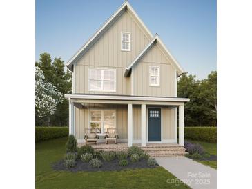 Charming two-story home featuring a welcoming front porch with seating and manicured landscaping at 110 Walters St, Huntersville, NC 28078
