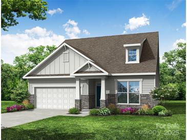Charming single-Gathering home with stone accents, covered entryway, and attached two car garage at 3009 Bent Willow Dr # 160, Indian Trail, NC 28079
