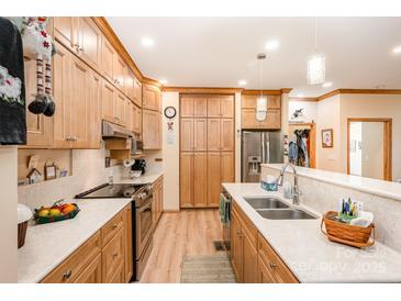 Well-lit kitchen featuring wood cabinets, stainless steel appliances, and white countertops at 809 Liberty Rd, Gold Hill, NC 28071