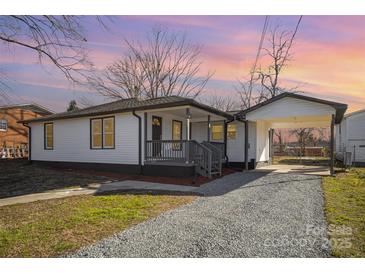Charming one-story home featuring a cozy front porch and adjacent covered carport, nestled on a well-maintained lot at 922 Grace Ave, Kannapolis, NC 28083