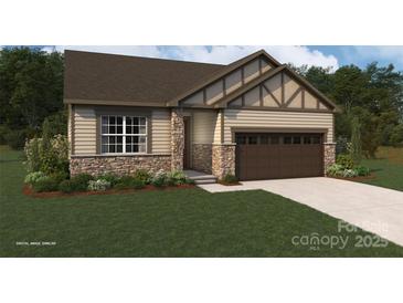 Charming single-Gathering home with stone accents, tan siding, a two-car garage, and manicured lawn at 2656 Tillman St, Monroe, NC 28112