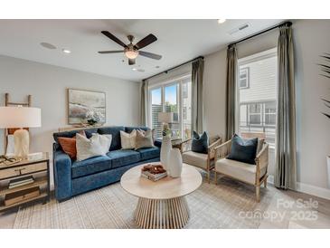 Cozy living room featuring a blue sofa, decorative pillows, and modern decor at 3210 Stelfox St, Charlotte, NC 28262