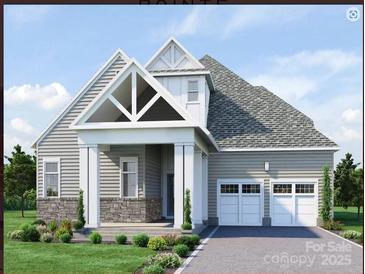Charming single-Gathering home showcasing a two-car garage, stone accents, and a well-manicured front yard with a gable entryway at 7443 Paddle Ln # 55, Sherrills Ford, NC 28673
