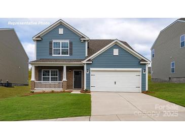 Charming two-story home with blue siding, brick accents, and a well-manicured lawn at 1348 Secrest Commons Dr, Monroe, NC 28112