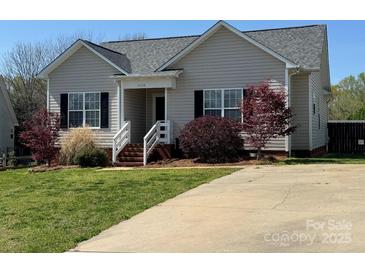 Charming one-story home boasts manicured lawn and inviting entryway at 1638 Marmot Pl, Concord, NC 28025