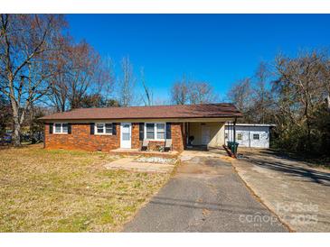 Charming brick home with a well-manicured front lawn and a classic design at 303 S Eastway Dr, Troutman, NC 28166