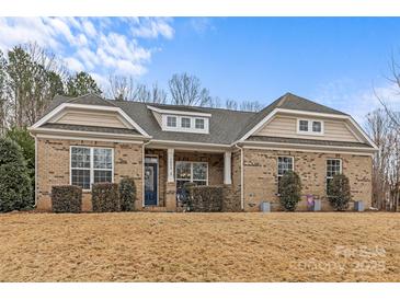 Charming single-story brick home featuring a well-manicured front lawn and a welcoming entrance at 3090 Tallgrass Blf, Rock Hill, SC 29732