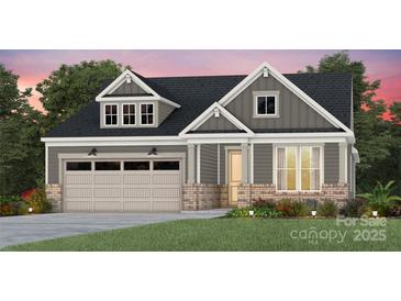 Charming home with a brick and siding exterior, attached two-car garage, and a manicured front lawn at 4762 Formation Ct # 062, Lancaster, SC 29720