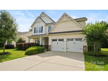 Inviting two-story home with a well-maintained lawn and a two-car garage at 5006 Sand Trap Ct # 142, Monroe, NC 28112