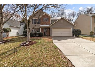 Charming two-story home with a two-car garage, brick accents and a well-manicured lawn at 9014 Arbor Creek Dr, Charlotte, NC 28269