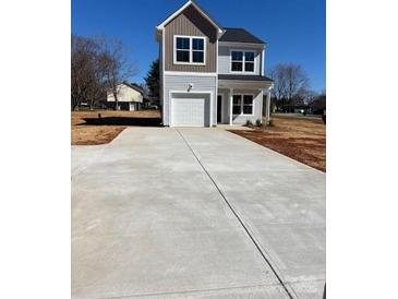 Charming two-story home with light siding, garage and a concrete driveway at 195 Bethesda Rd, Statesville, NC 28625