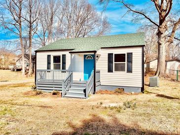 Charming single-story home with a blue front door and a gray porch and matching shutters at 2123 Ravendale St, Kannapolis, NC 28083