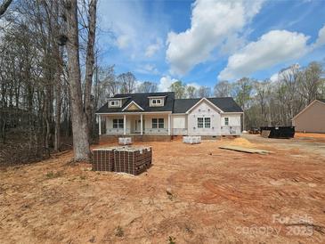 New construction home featuring a welcoming front porch and a classic black roof, set on a spacious lot at 601 Shiloh Unity Rd, Lancaster, SC 29720