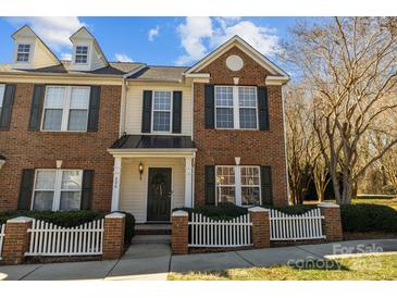 Charming two-story brick home with a welcoming front porch and a well-maintained, attractive yard at 604 Atherton Way, Rock Hill, SC 29730