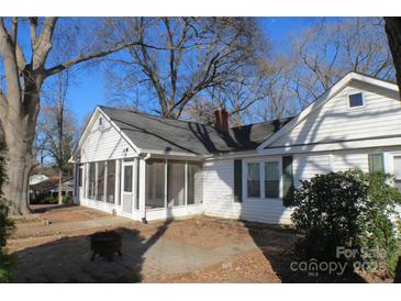 Cozy home featuring a screened porch, white siding, and a welcoming outdoor patio area perfect for entertaining at 802 Lewis St, Gastonia, NC 28054