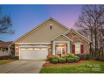 Charming single-Gathering home featuring a stone and siding exterior with a well-manicured front yard at 1209 Waypoint Ct, Matthews, NC 28104