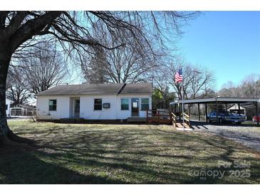 Charming single-story home with a white exterior, complemented by a spacious yard and an open carport at 1433 Buffalo Shoals Rd, Catawba, NC 28609