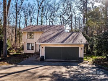 Charming two-story home featuring an attached garage and a neutral color palette surrounded by lovely trees at 1590 Daybreak Ridge Rd, Kannapolis, NC 28081