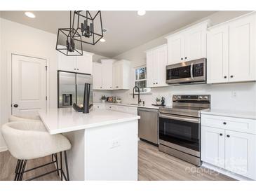 Modern kitchen features stainless steel appliances and white cabinetry at 1608 Breezewood Dr, Charlotte, NC 28262