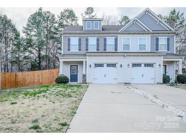 Charming townhome featuring attached garages, well-maintained lawn and gray accented shutters at 203 Makayla Ct, Fort Mill, SC 29715