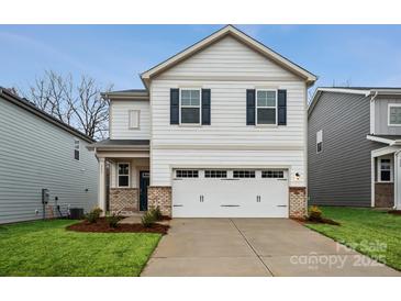 Charming two-story home featuring a white garage door, neutral siding and manicured landscaping at 302 Bezelle Ave, York, SC 29745