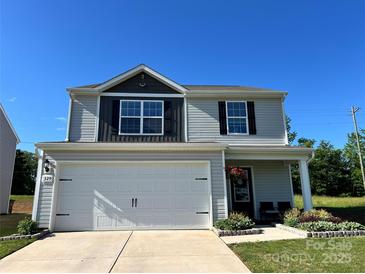 Charming two-story home boasts a two-car garage, covered porch, and lovely curb appeal at 329 Aniston Ln, Shelby, NC 28152
