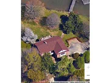 Aerial view of a waterfront home with a red roof, dock, and mature trees at 4220 Honeysuckle Rd, Rock Hill, SC 29732