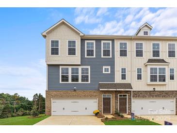 New townhome features a brick and siding facade, attached garages, and well-maintained landscaping at 4407 Reed Creek Dr, Sherrills Ford, NC 28673