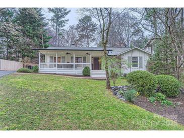 Charming single-story home with a welcoming front porch and well-maintained lawn at 121 Wonderwood Dr, Charlotte, NC 28211
