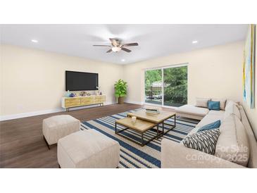 Bright living room featuring hardwood floors, neutral paint, and sliding doors to a patio at 1323 Queens Rd # 218, Charlotte, NC 28207