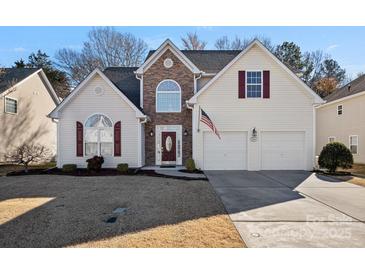 Charming two-story home with stone accents, double garage, and a well-manicured lawn at 2031 Covered Bridge Ct, Rock Hill, SC 29732