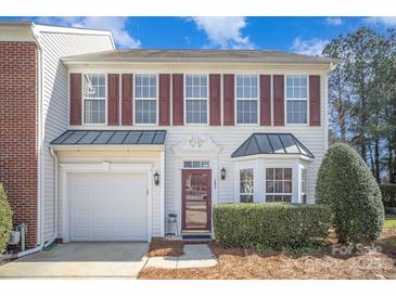 Charming two-story home featuring red shutters, white siding, well-kept landscaping, and an attached one-car garage at 151 Kallie Loop, Mooresville, NC 28117