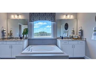 Luxurious bathroom with soaking tub and dual sinks offering a serene view at 173 Glenn Dr, Mooresville, NC 28115