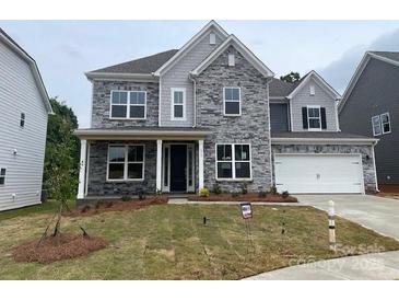 Charming two-story home featuring a stone facade, a welcoming front porch, and an attached two-car garage at 173 Glenn Dr, Mooresville, NC 28115