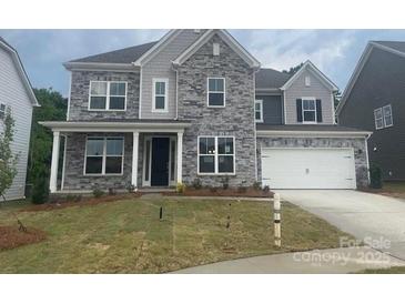 Charming two-story home with stone accents, a front porch, and a two-car garage at 173 Glenn Dr, Mooresville, NC 28115