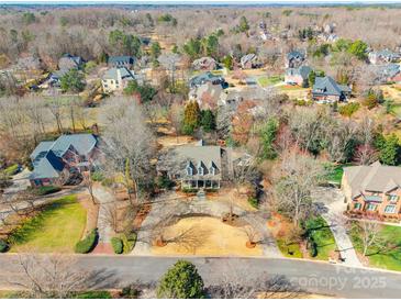 A stunning aerial view of a home nestled in a wooded neighborhood with a circular driveway at 1996 Farrow Dr, Rock Hill, SC 29732