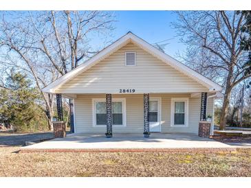 Close-up of the home's facade, highlighting the charming front porch with decorative columns and a brick base at 28419 Nc Hwy 73 Hwy, Albemarle, NC 28001