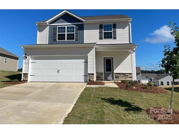 Charming two-story home featuring a two-car garage, stone accents, and manicured lawn at 3358 Burberry Dr, Gastonia, NC 28052