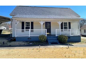Charming single-story home with inviting front porch and meticulously maintained front lawn at 3481 Roberta Rd, Concord, NC 28027
